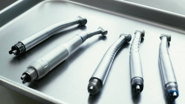 Selection of dental turbine handpieces on metal tray. Professional tools for oral healthcare