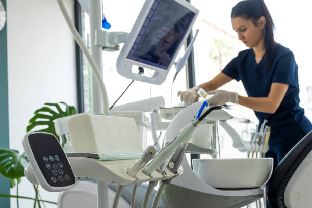 Dental assistant checking equipments in dental room